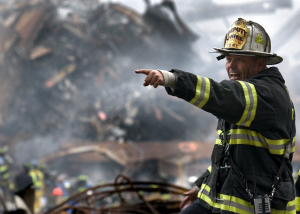 Disaster relief - firefighter pointing on site at fire